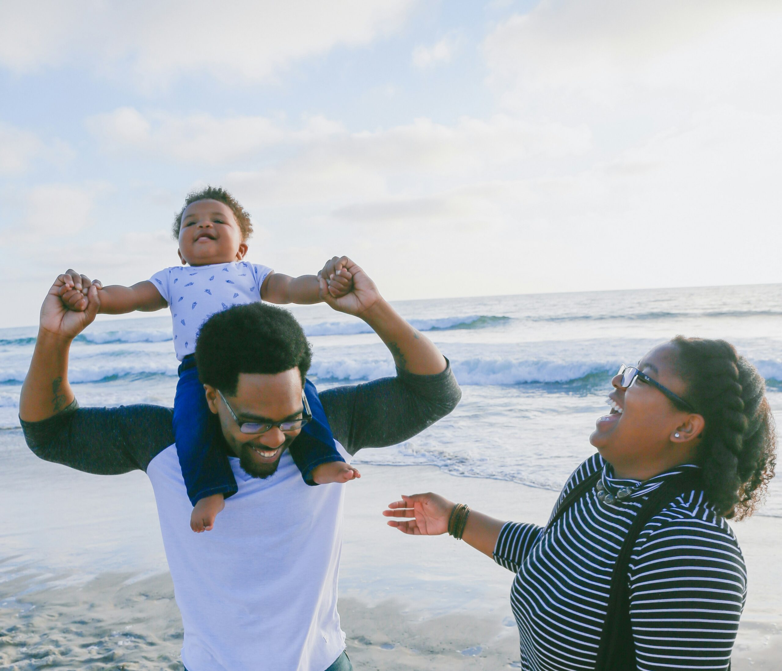 Happy family enjoying time at the beach in San Diego, symbolizing the freedom provided by Next Wave Cleaning Services