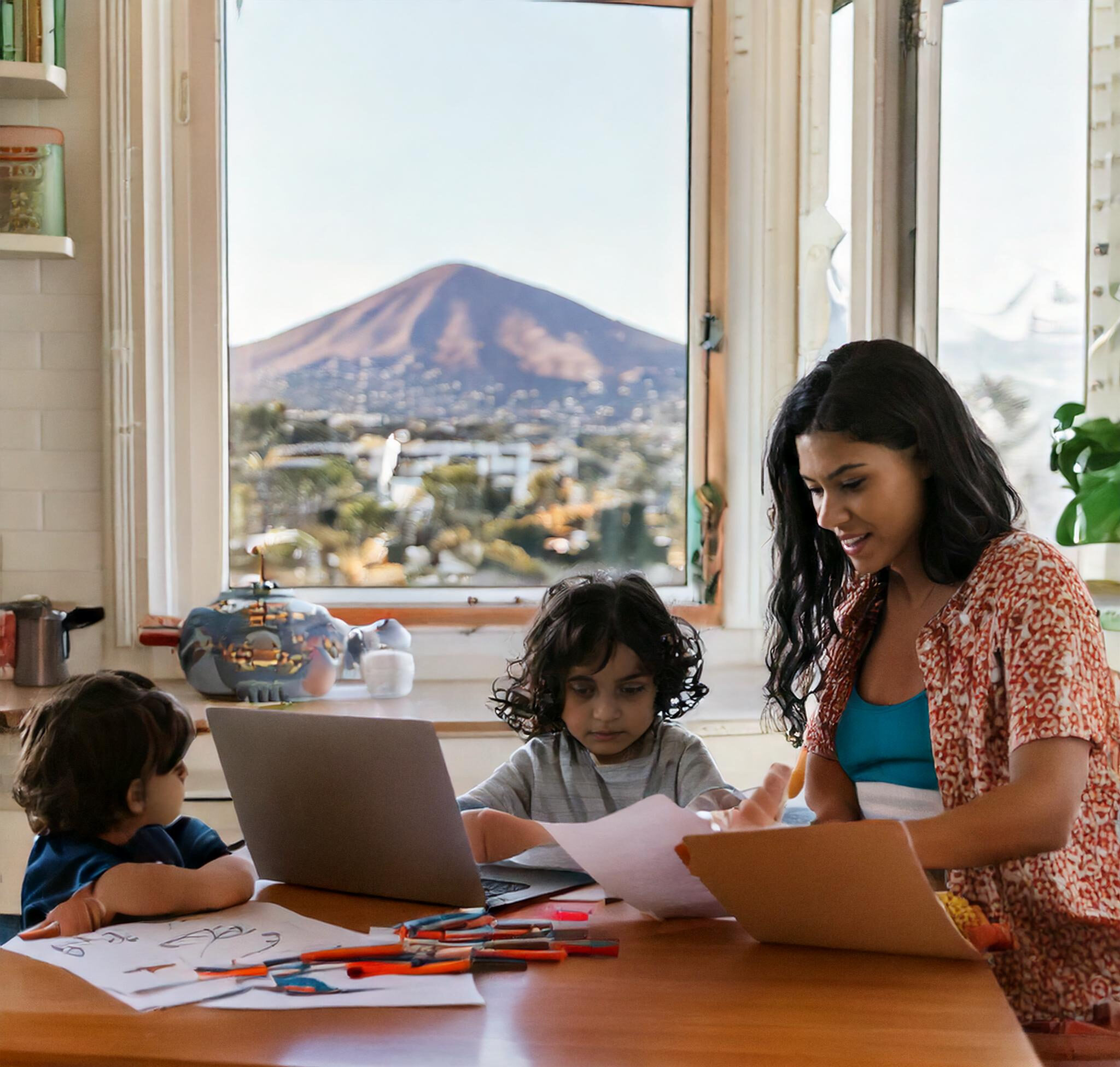 Busy parent working with children at a clean and organized kitchen table, overlooking a stunning San Diego view